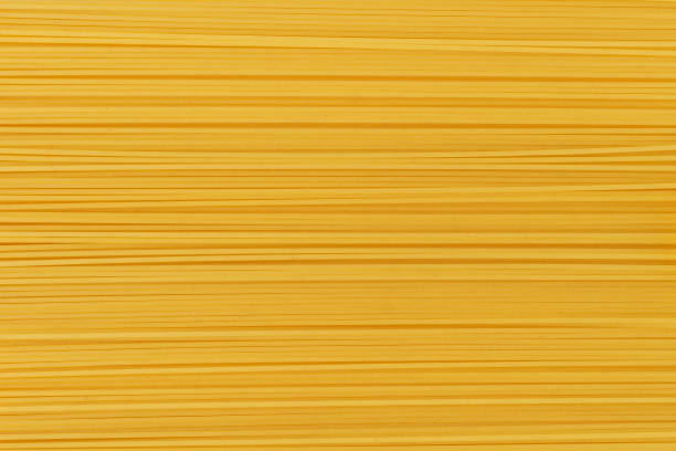 istock Dry uncooked spaghetti pasta as a background. 1169298416
