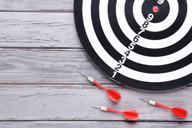 istock Dartboard with darts on wooden table 1169298476