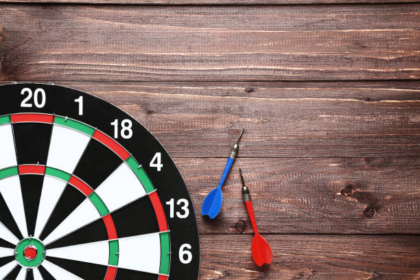istock Dartboard with darts on brown wooden table 1169298595