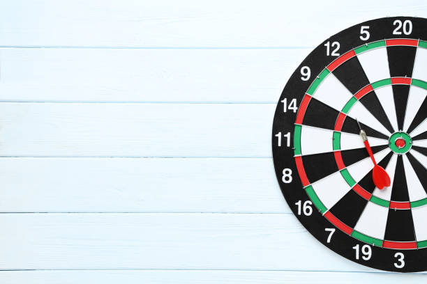 istock Dartboard with darts on wooden table 1169298610