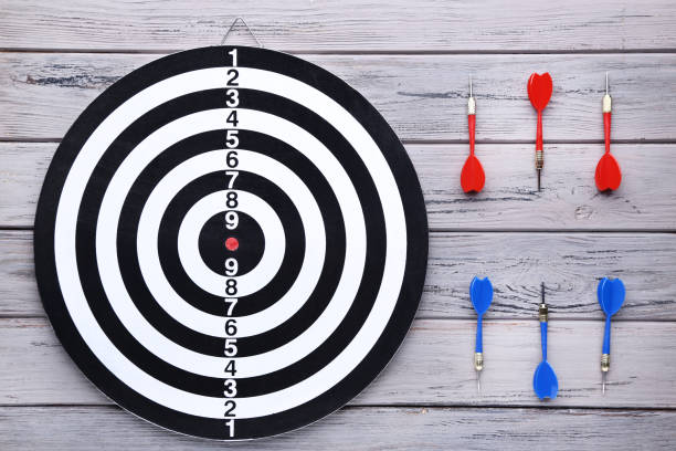 istock Dartboard with darts on wooden table 1169298687