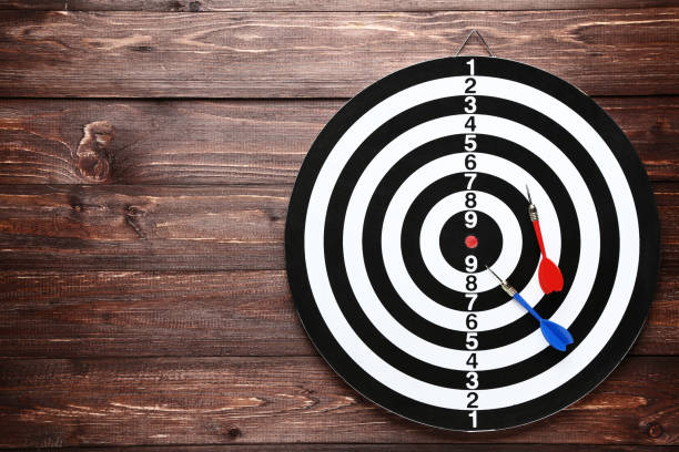istock Dartboard with darts on brown wooden table 1169298713