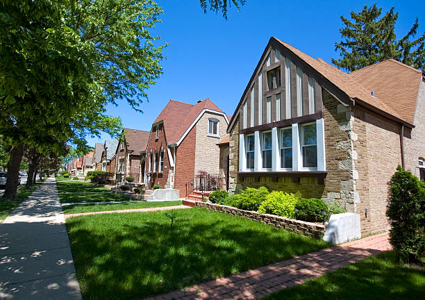 A row of old wood homes surrounded by green trees during the summer in Andersonville Chicago