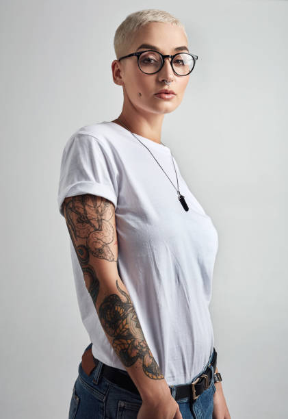 The coolest nerd you'll ever meet Portrait of an attractive and stylish young woman posing against a grey background free tatto designs stock pictures, royalty-free photos & images