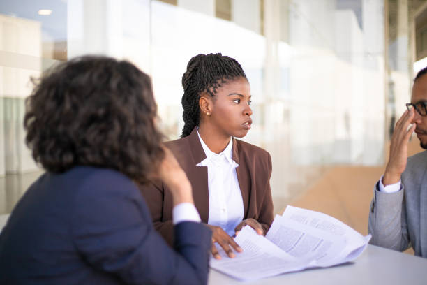 istock Confident female legal adviser checking customers documents 1169303396