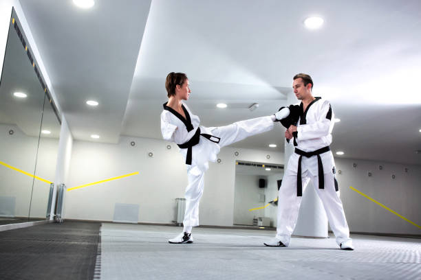 istock Physically challenged young woman in sports practicing taekwondo 1169304588