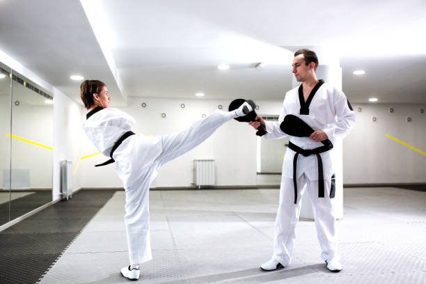 istock Physically challenged girl in martial arts training taekwondo 1169307005