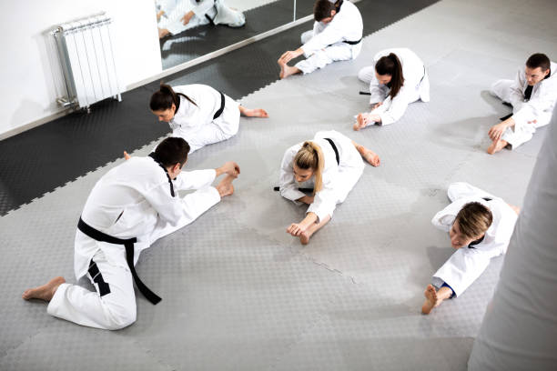 istock Group of athletes accompanied with physically challenged athlete preparing for a combat training workout 1169308384