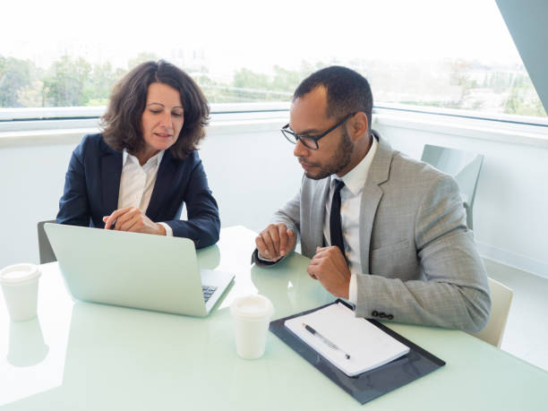 istock Female manager teaching male newcomer 1169312210