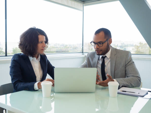 istock Shocked colleagues using computer in meeting room 1169312822