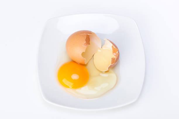 istock Broken raw egg  in a porcelain dish on a white 1169313289