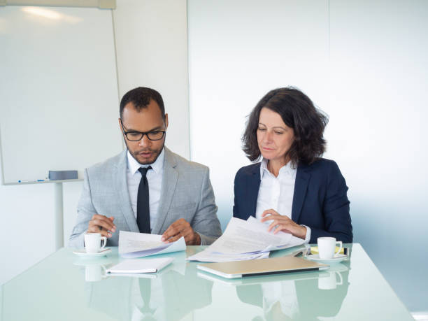 istock Business professionals examining contract text 1169313343