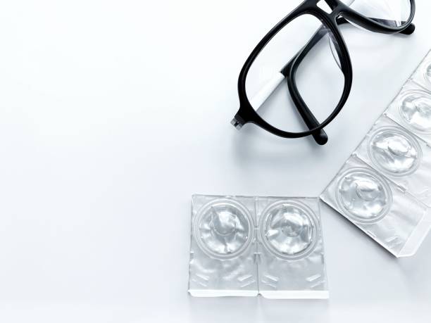 contact lens blisters and black glasses on a white background. - blister pack pill medicine healthcare and medicine imagens e fotografias de stock