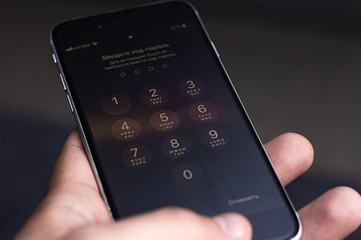 Entering a pin or secret code on a smartphone. The screen with the numbers of a modern smartphone.
