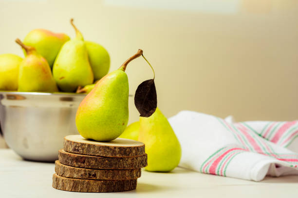 istock fresh and green pears on a wooden table 1169314874