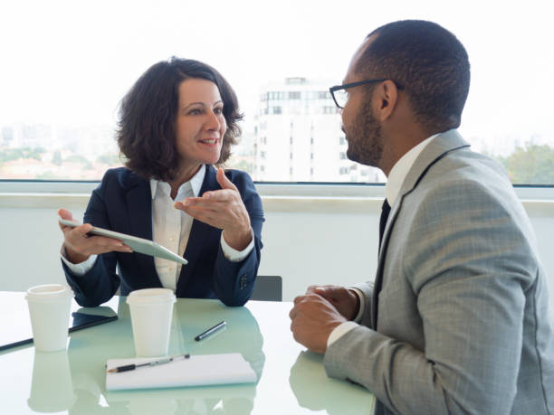 istock Senior employee telling newcomer about ongoing project 1169315476