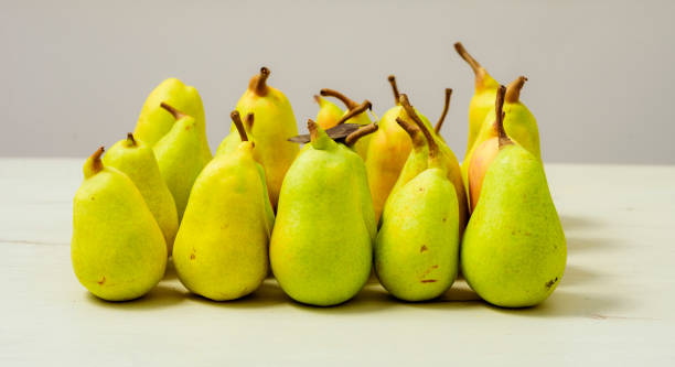 istock fresh and green pears on a wooden table 1169316087