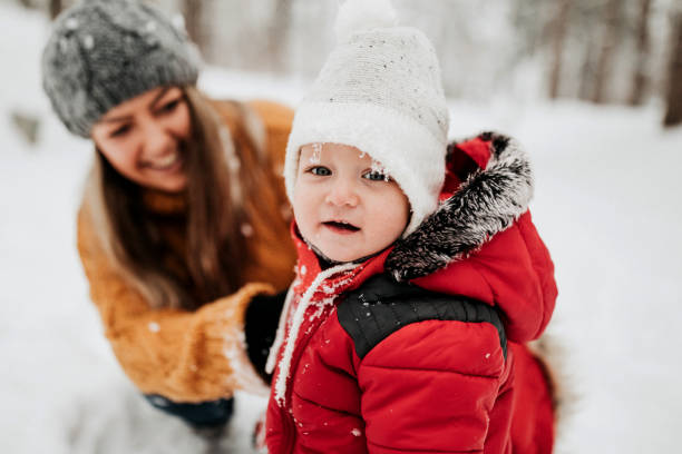 istock Mother enjoying in snow with her son 1169316404