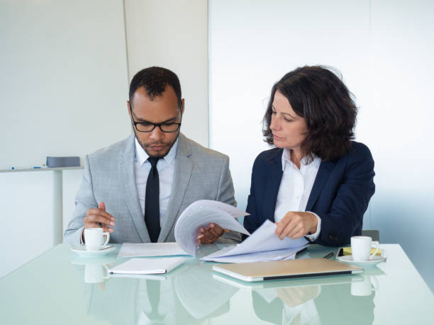 istock Business colleagues checking agreement text 1169316405