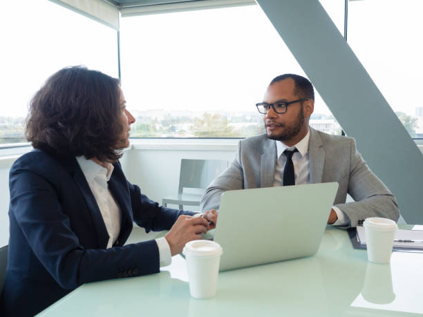 istock Business team watching and discussing project presentation 1169317911