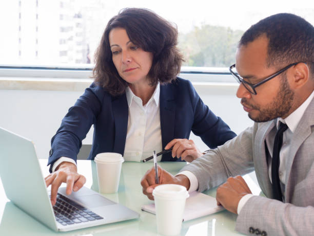 istock Female trainer showing laptop screen 1169318239