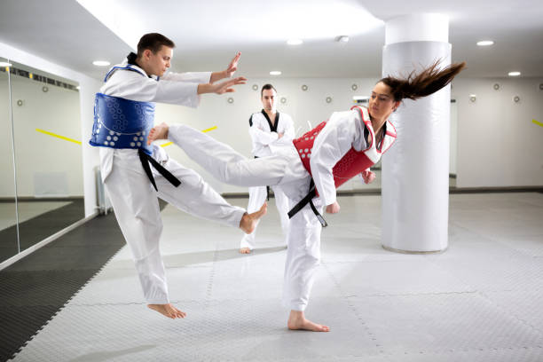 istock Two martial art fighters having a taekwondo combat 1169319255