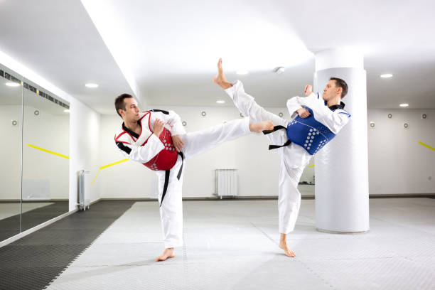 istock Two guys in a taekwondo combat 1169319525