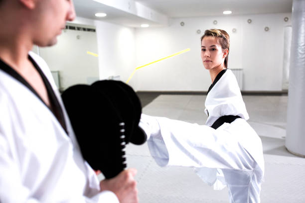 istock Young cute girl with physical disability focused on kicking technique 1169319772