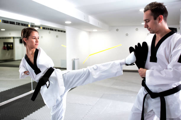 istock Young cute girl with physical disability focused on kicking technique 1169319816