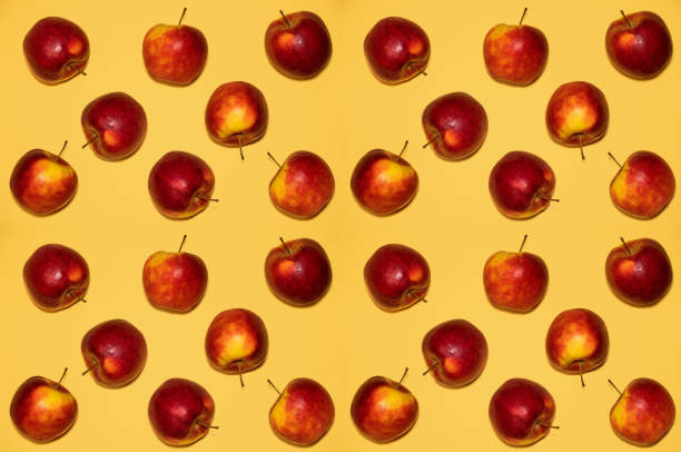 istock ripe red apples lie on a yellow 1169320341