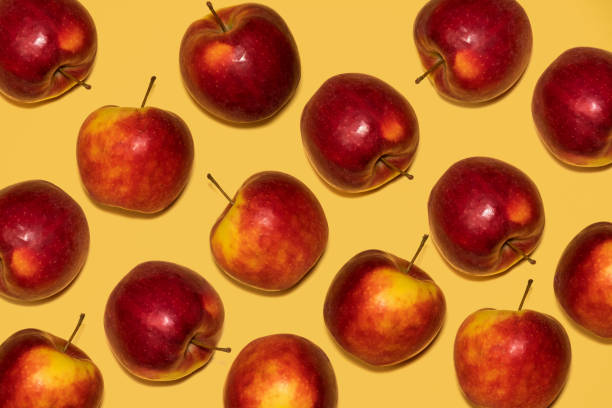 istock ripe red apples lie on a yellow 1169320342
