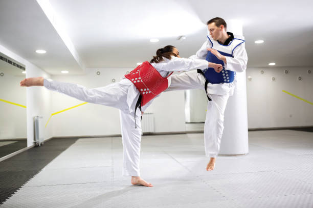istock A Guy and a girl in close taekwondo combat training 1169320376