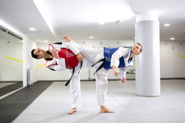 istock Two guys in a taekwondo combat 1169320399