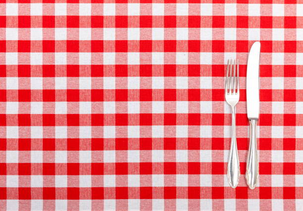 istock Old silver cutlery on checkered tablecloth 1169320490