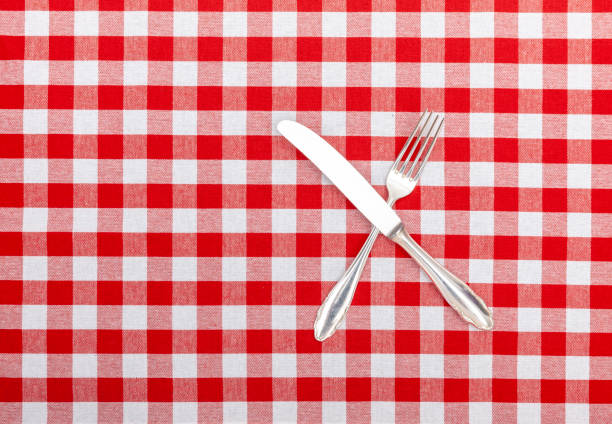 istock Old silver cutlery on checkered tablecloth 1169320550
