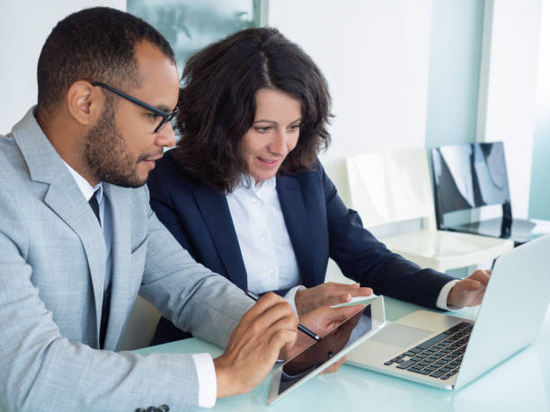 istock Business colleagues watching and discussing presentation 1169321697