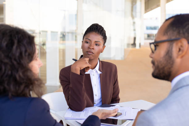 istock Multiethnic business partners discussing contract terms 1169322116