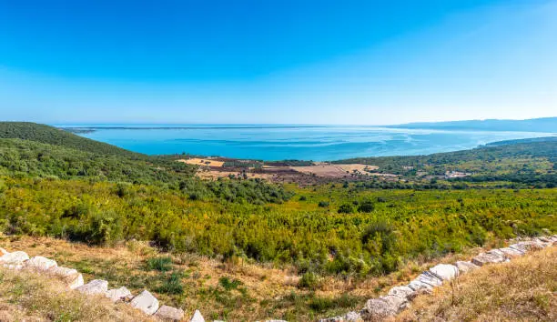 large panoramic of lake Varano in Gargano - Puglia - Italy - at the horizon the adriatic sea .