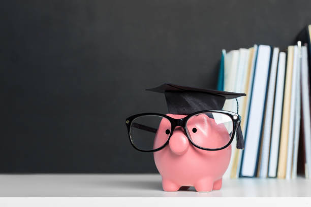 College graduate student diploma piggy bank College graduate student diploma piggy bank financial education stock pictures, royalty-free photos & images