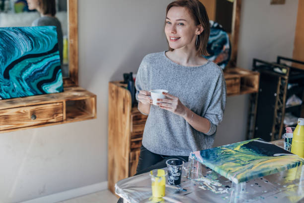 istock Beautiful lady artist in art studio 1169324665