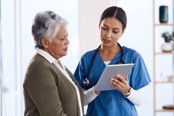 This might help you understand the condition better Shot of a young doctor using a digital tablet during a consultation with a senior woman female nurse photos stock pictures, royalty-free photos & images
