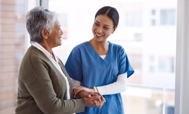 I'll always be here by your side Shot of a young nurse caring for a senior woman patient stock pictures, royalty-free photos & images