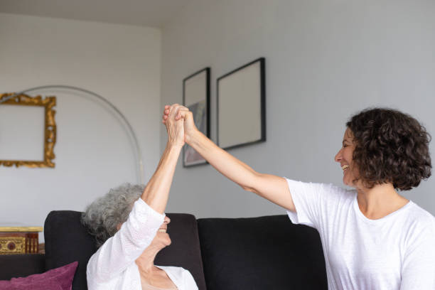 istock Cheerful mother and daughter giving high five 1169327478