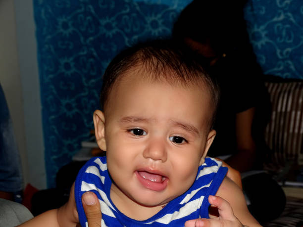 Baby boy weeping portrait at home.