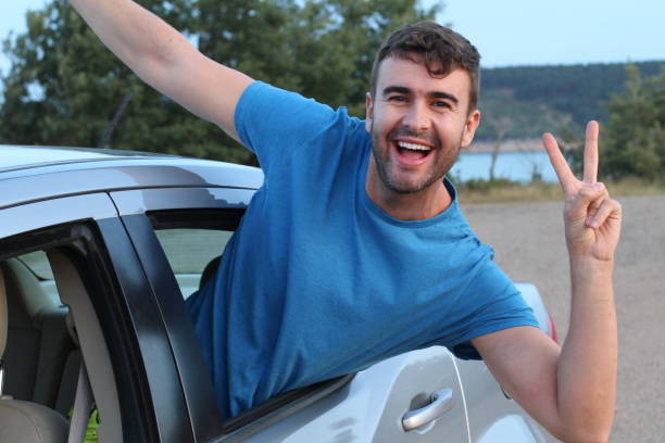 istock Free spirited car passenger showing peace sign 1169327939