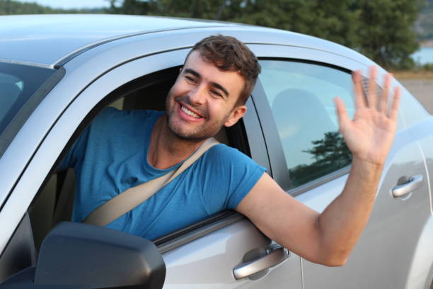 istock Educated driver saluting a friend 1169327950