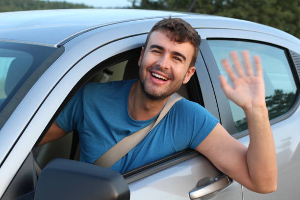 istock Educated driver saluting a friend 1169328001