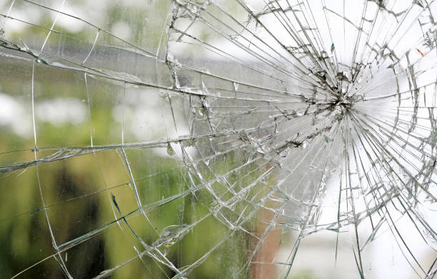 istock Old cracked dirty broken glass window background. 1169328134