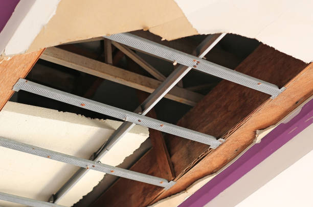 istock Ceiling panels house broken huge hole. Damaged ceiling. 1169328747