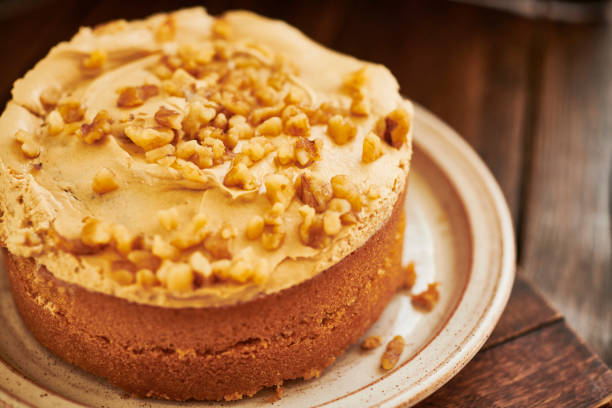 istock Coffee and walnut cake on aged dark wood rustic surface. 1169328990